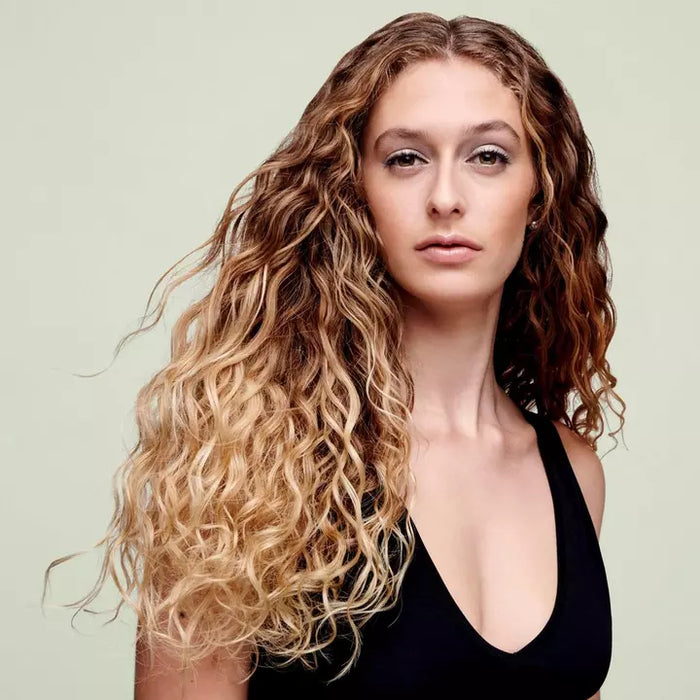 Deva Curl One Condition Original - Rich Cream Conditioner being used on model to document before and after use effects