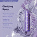 ENJOY Clarifying Spray bottle with water droplets on a purple background