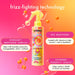 Amika frizz-fighting hair treatment spray with product details on a colorful background