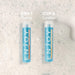 Two bottles of 'ENJOY' shampoo on a textured gray background with 'Step 1 Cleanse' and 'Step 2 Condition' text.