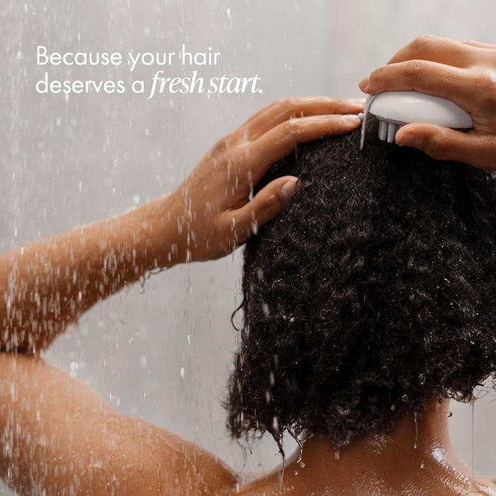 Person washing hair with a shower head, with text 'Because your hair deserves a fresh start.'