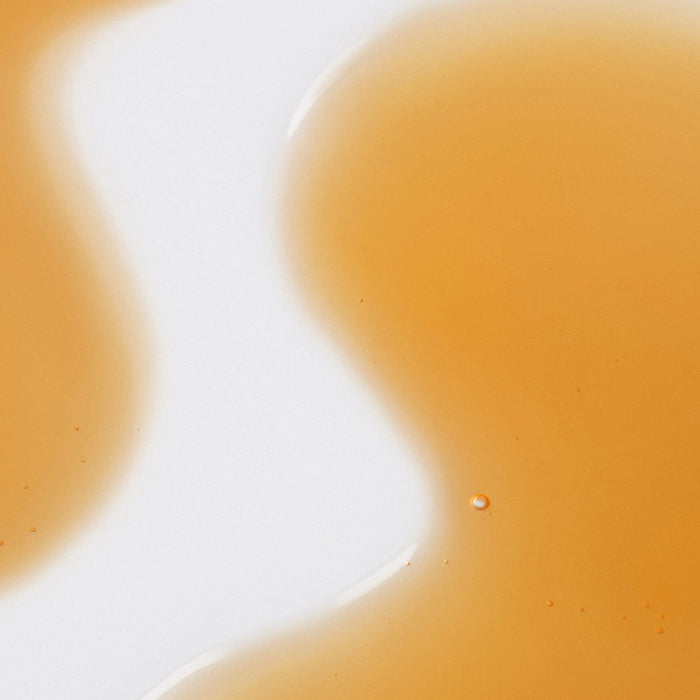 Close-up of a yellowish-orange liquid product texture 